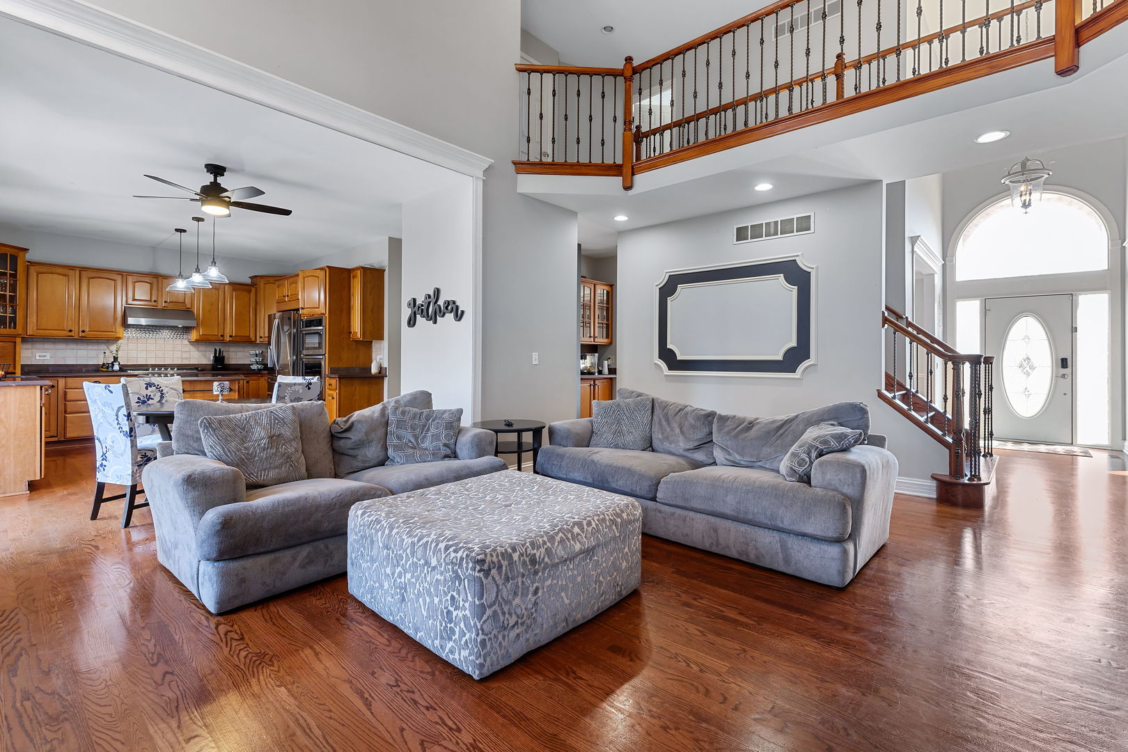 Undisclosed Address Aurora, IL 60502 - Photo 3 of 18 a living room with furniture and a wooden floor