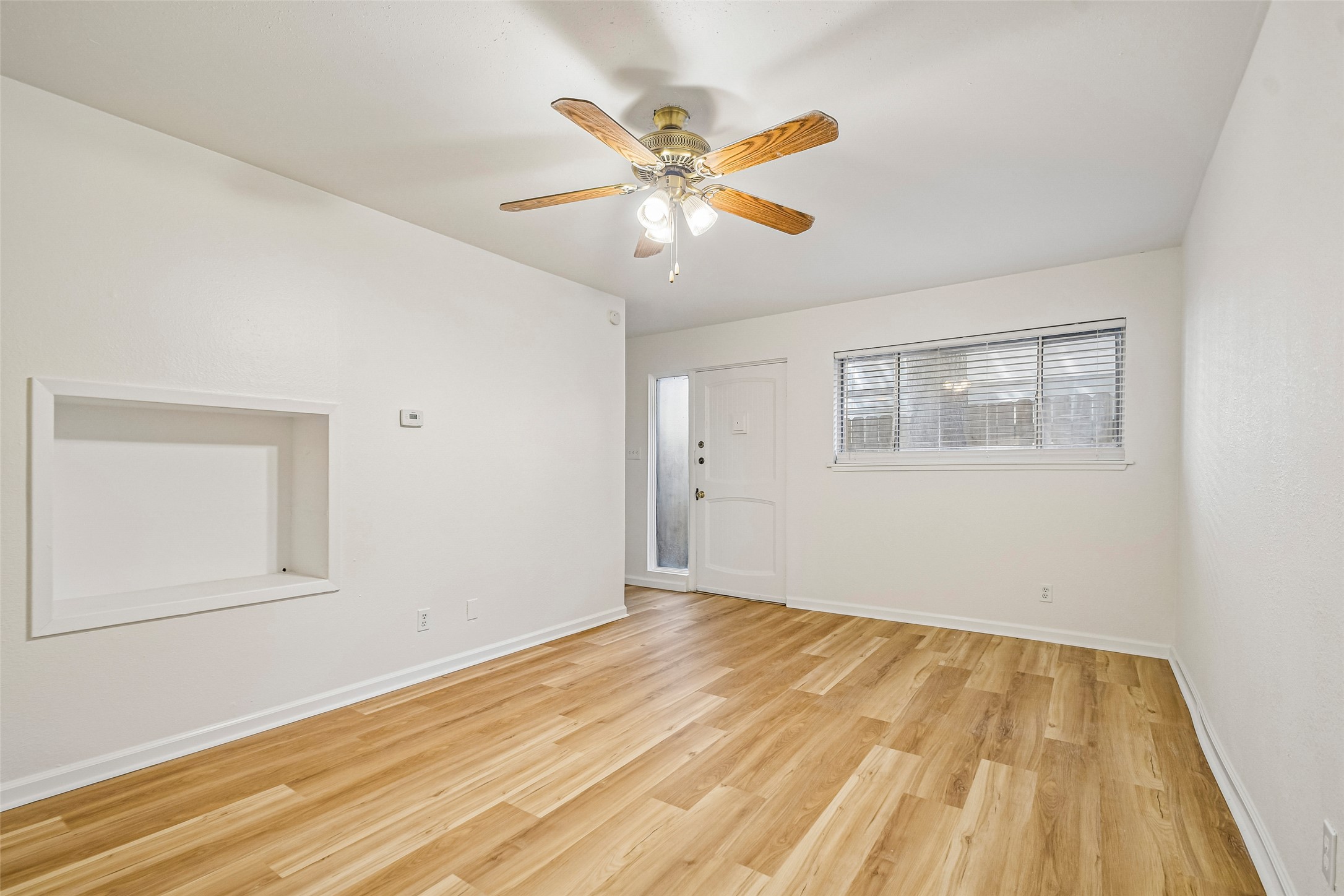 2413 Leon Street, Unit 104 Austin, TX 78705 - Photo 4 of 26 a view of an empty room with wooden floor and a ceiling fan