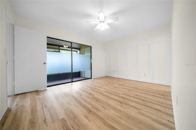 a view of empty room with wooden floor