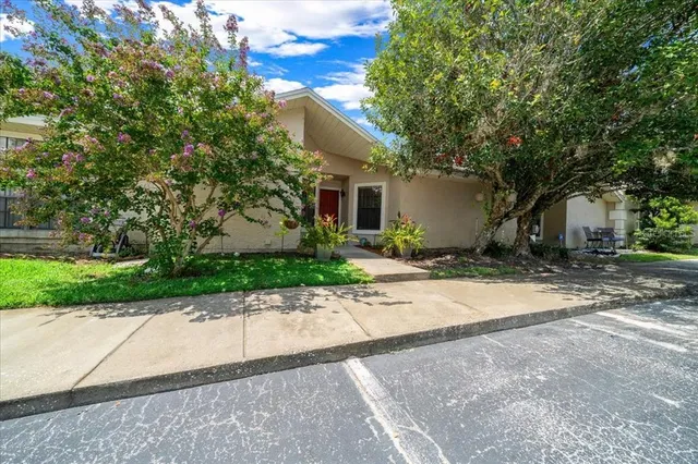 a front view of a house with a yard and a garage