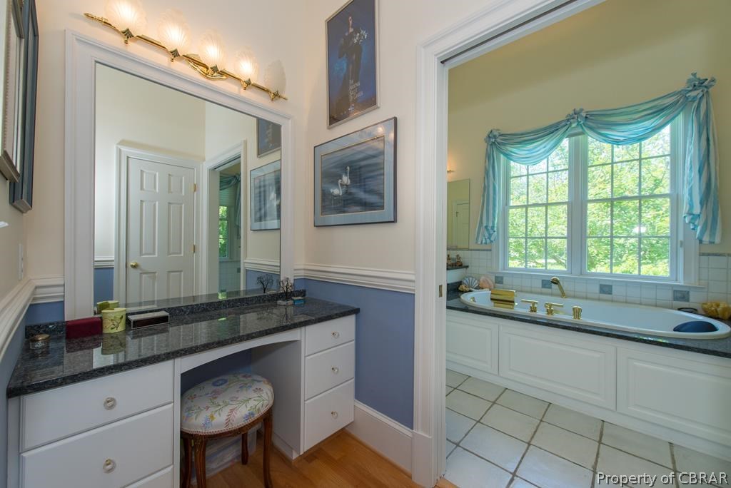 1193 West Point Road Lancaster, VA 22503 - Photo 34 of 50 a bathroom with a granite countertop sink and a mirror