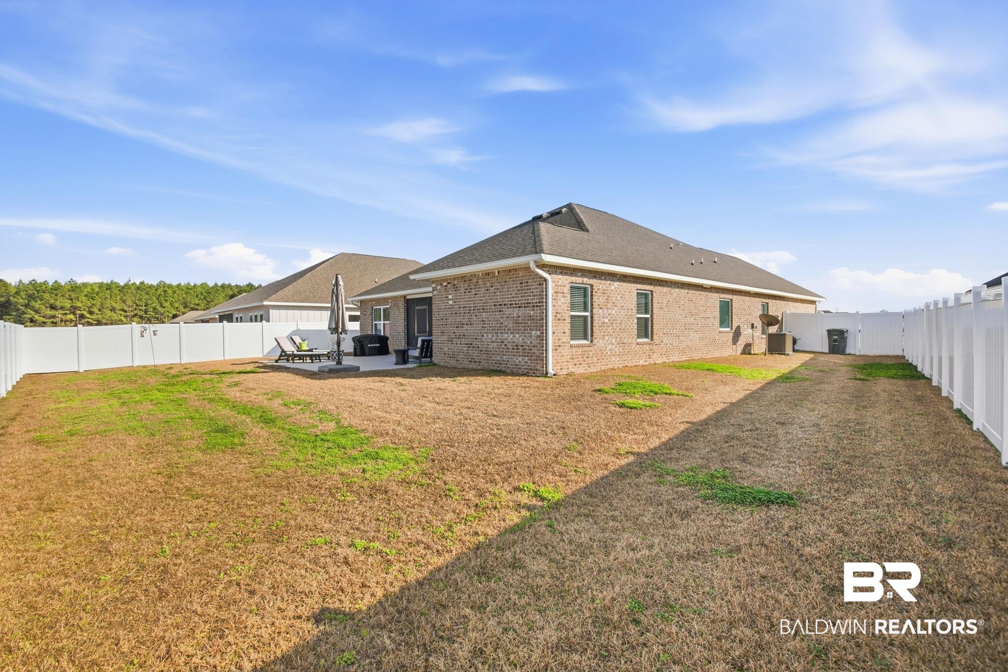 11123 Genuine Risk Circle Daphne, AL 36526 - Photo 48 of 67 Rear view of property featuring a fenced backyard, a patio, brick siding, and a shingled roof