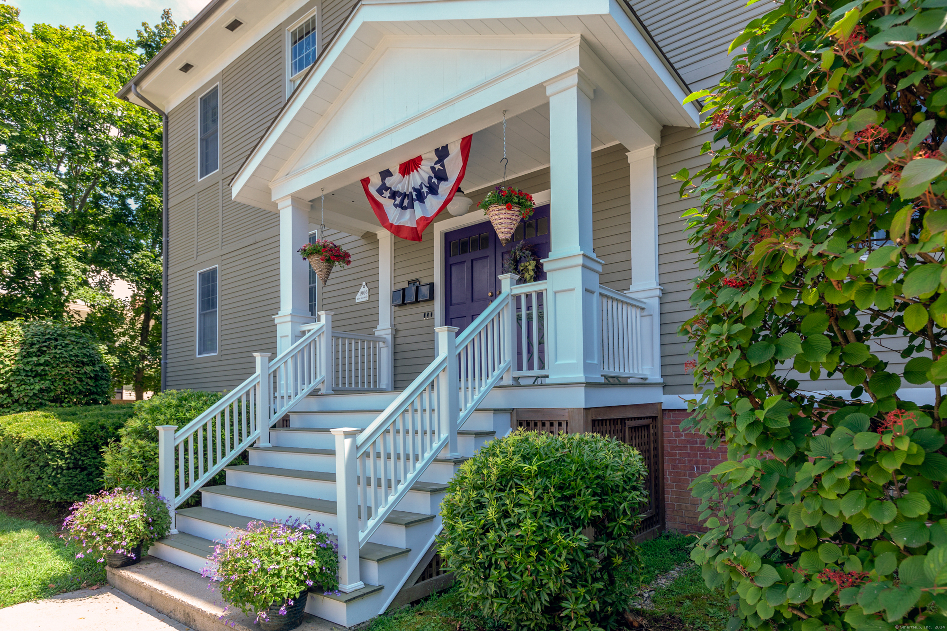 103 Boston Street, Unit C Guilford, CT 06437 - Photo 1 of 33 a view of a building with stairs and flowers