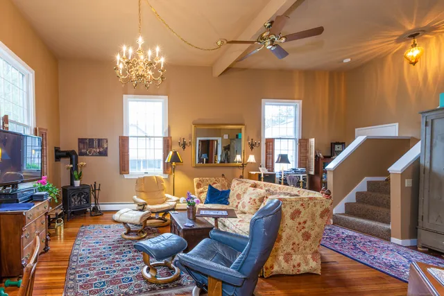 a living room with furniture windows and a chandelier
