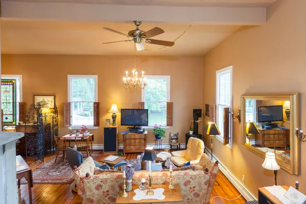 a living room with lots of furniture and chandelier