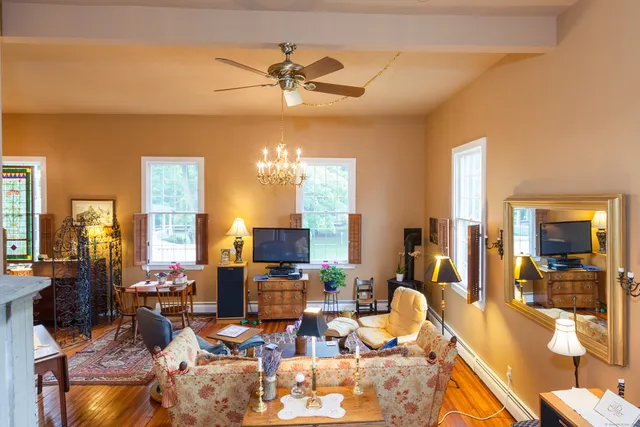 a living room with lots of furniture and chandelier