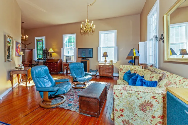 a living room with furniture fireplace and a chandelier