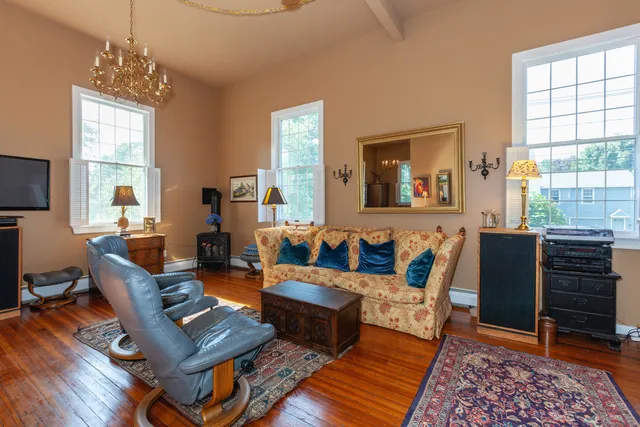 a living room with fireplace furniture and a window