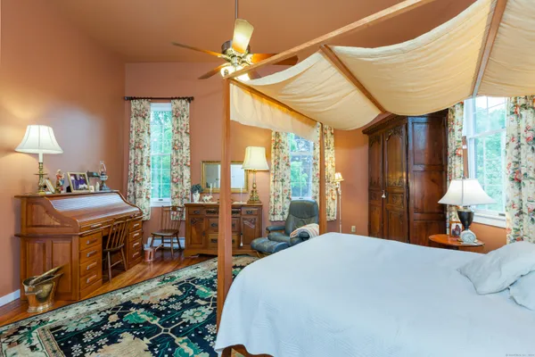 a bedroom with a bed and a chandelier