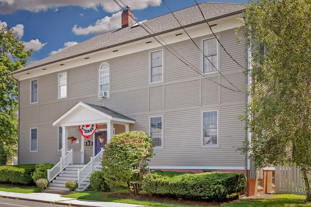 a front view of a building with garden