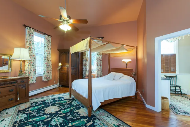 a bedroom with a bed and window