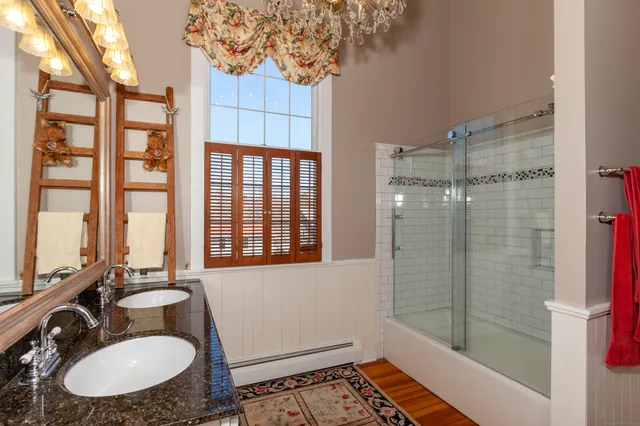 a bathroom with a sink toilet a mirror and shower