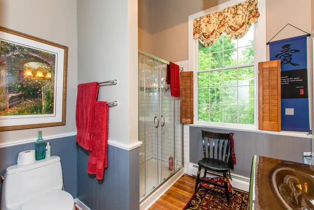 a bathroom with a toilet a sink and a window