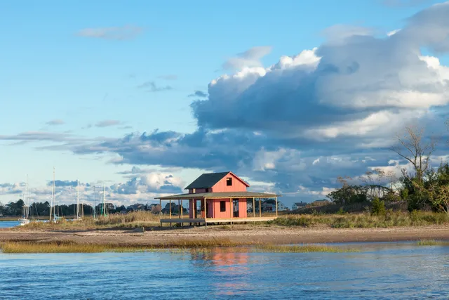 a front view of a house with a lake view