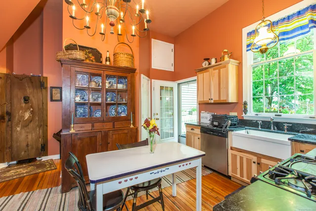 a kitchen with a table chairs and a stove