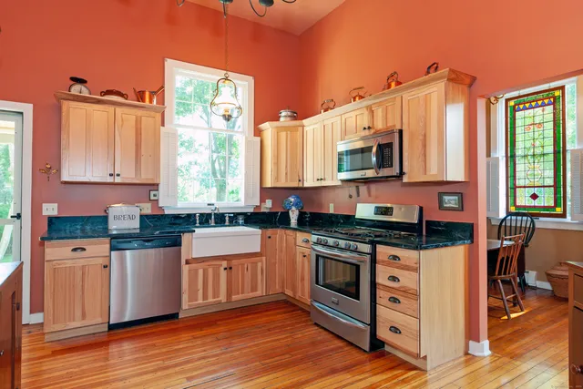 a kitchen with stainless steel appliances a stove top oven and a refrigerator