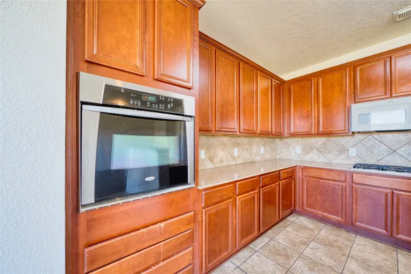 a kitchen with granite countertop stainless steel appliances sink and cabinets