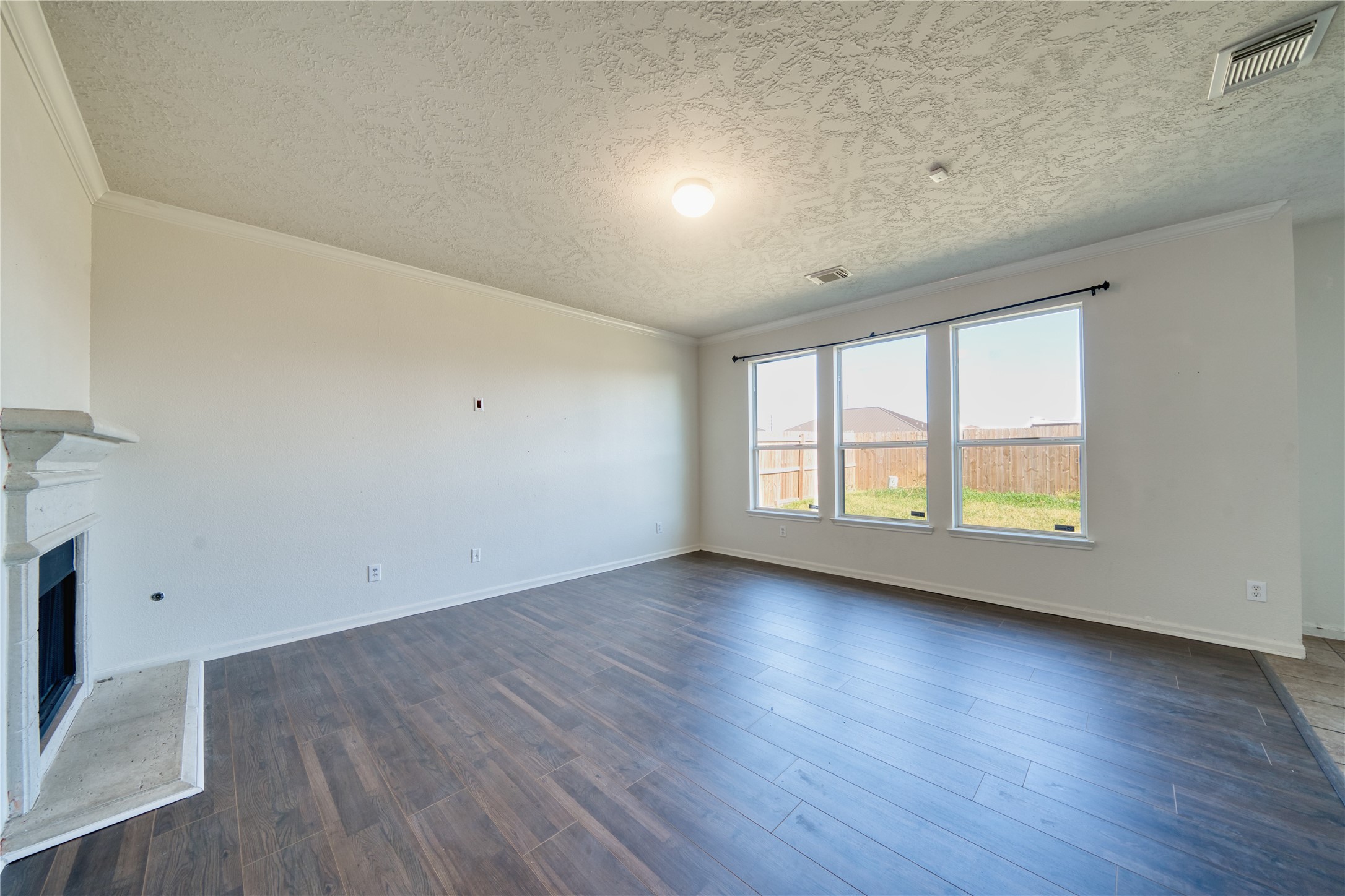 6610 Autumn Sunset Lane Spring, TX 77379 - Photo 17 of 45 an empty room with wooden floor and windows