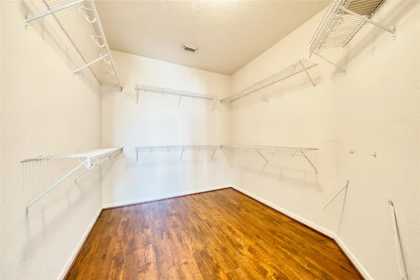 a view of a room with wooden floor