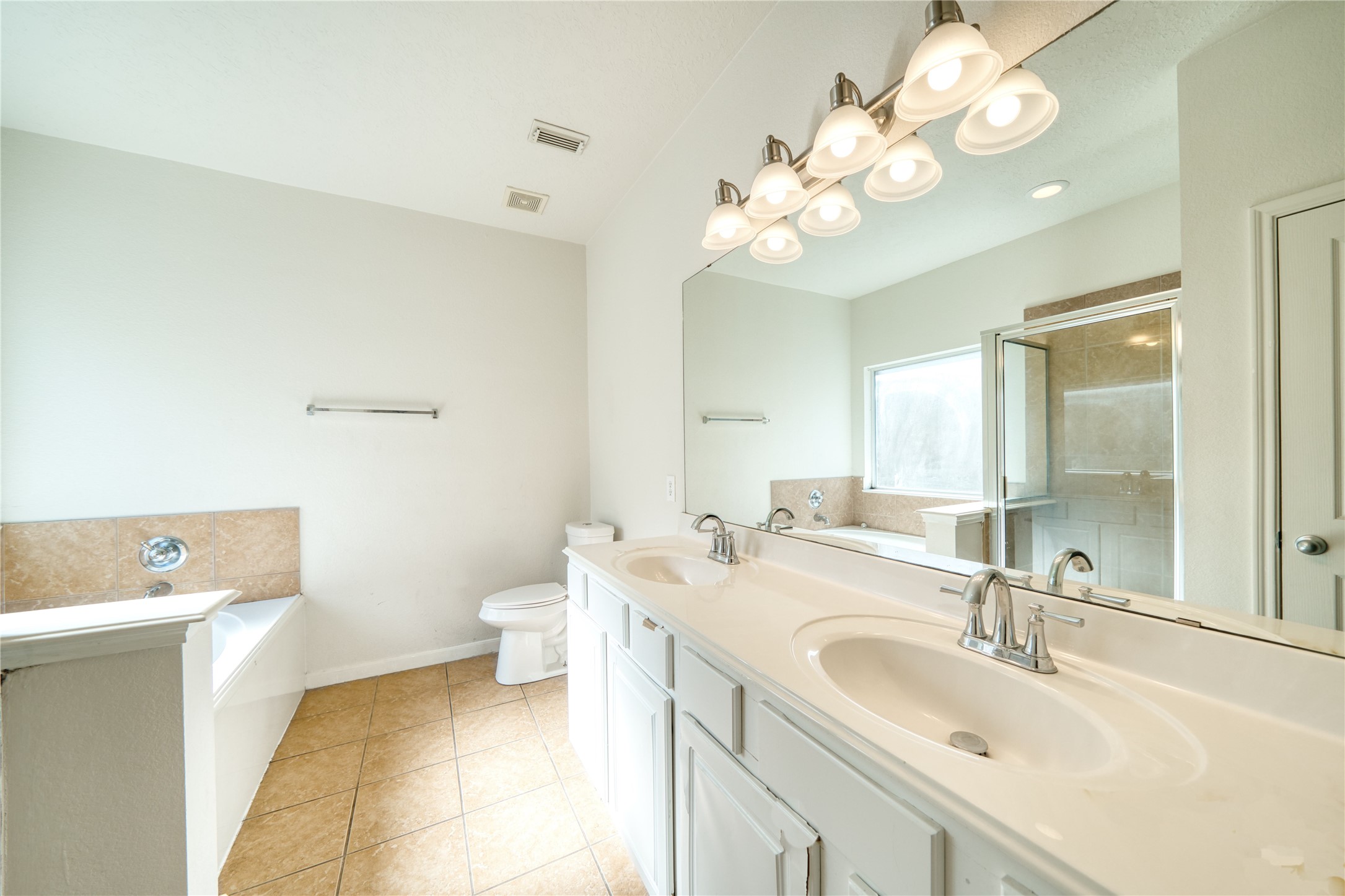 6610 Autumn Sunset Lane Spring, TX 77379 - Photo 25 of 45 a bathroom with a sink a toilet and a mirror