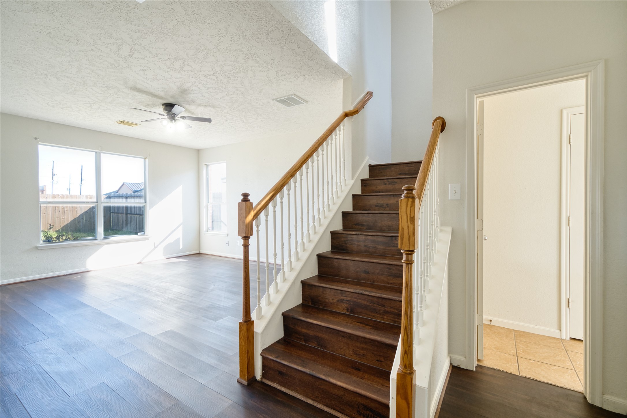 6610 Autumn Sunset Lane Spring, TX 77379 - Photo 28 of 45 a view of staircase with wooden floor and front door