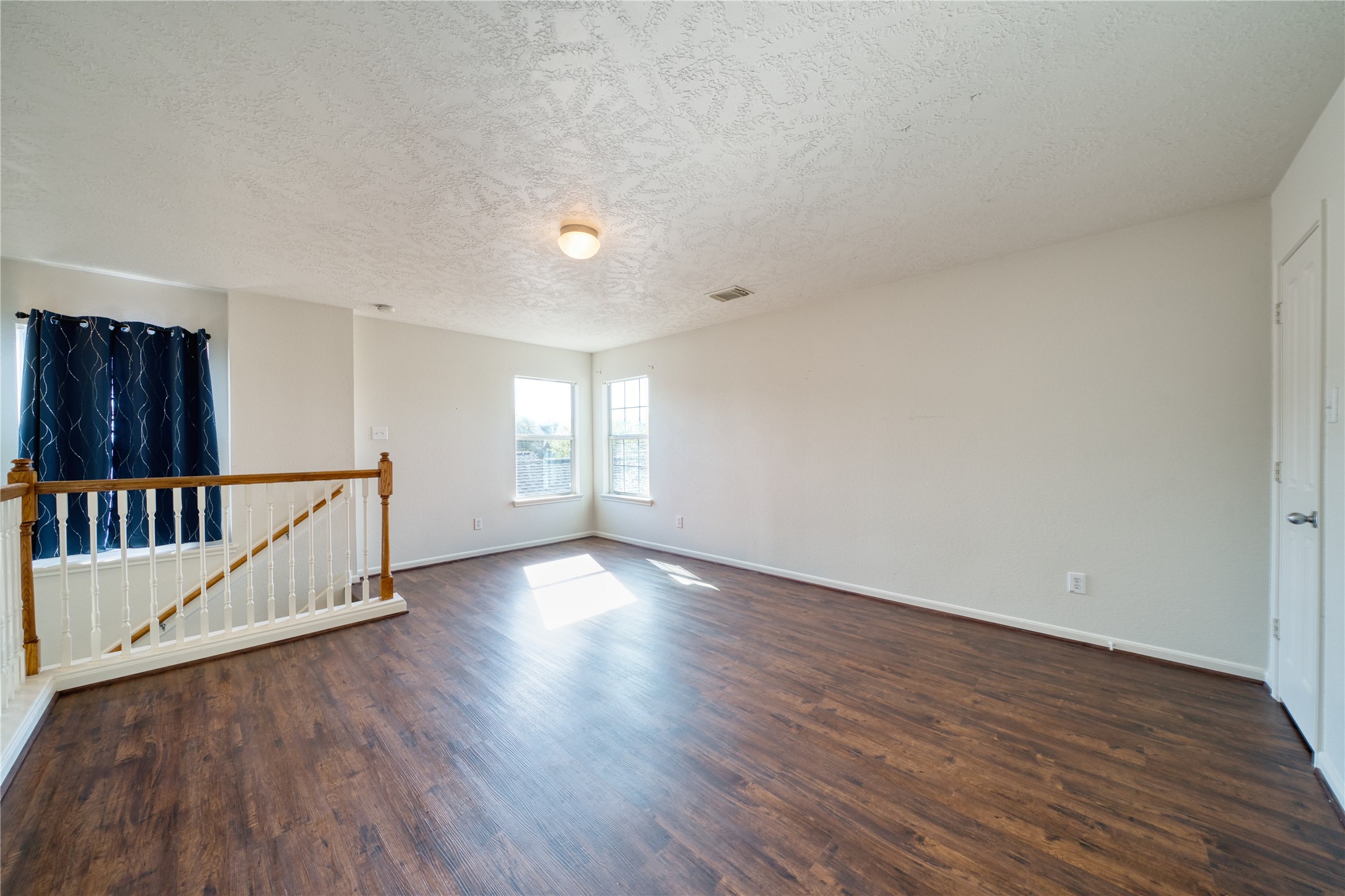 6610 Autumn Sunset Lane Spring, TX 77379 - Photo 33 of 45 a view of an empty room with wooden floor and a window
