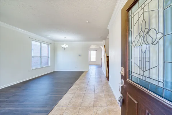 a view of a hallway with wooden floor and glass door