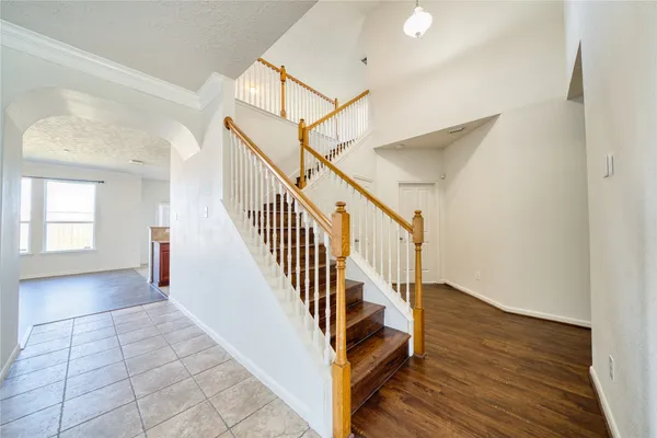 a view of entryway and hall with wooden floor