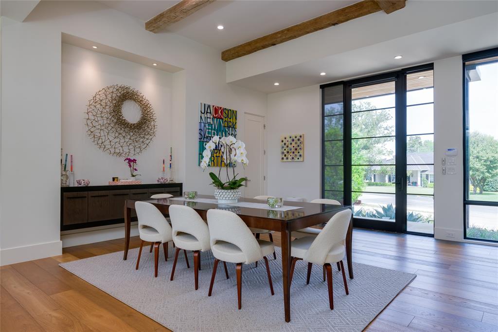 5736 Stonegate Road Dallas, TX 75209 - Photo 7 of 29 Hardwood flooring, exposed ceiling beams, recessed lighting, built-in wall niche with integrated lighting, and expansive floor-to-ceiling windows