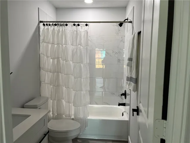 a bathroom with a toilet and a bathtub
