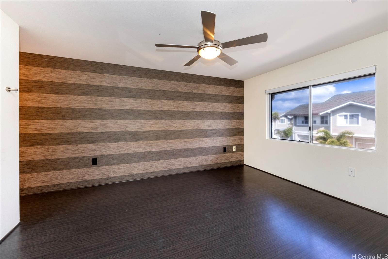 92-1475 Ali'inui Drive, Unit 20B Kapolei, HI 96707 - Photo 11 of 18 a view of room with window and wooden floor