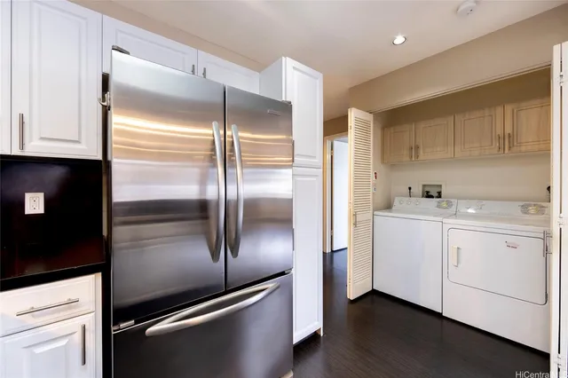 a kitchen with cabinets stainless steel appliances and a window