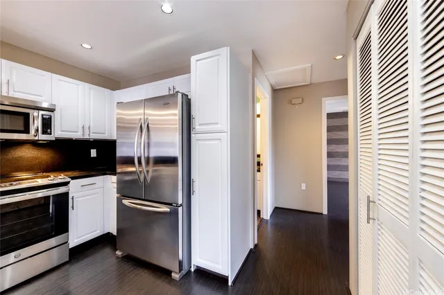 a kitchen with stainless steel appliances a refrigerator and a stove top oven