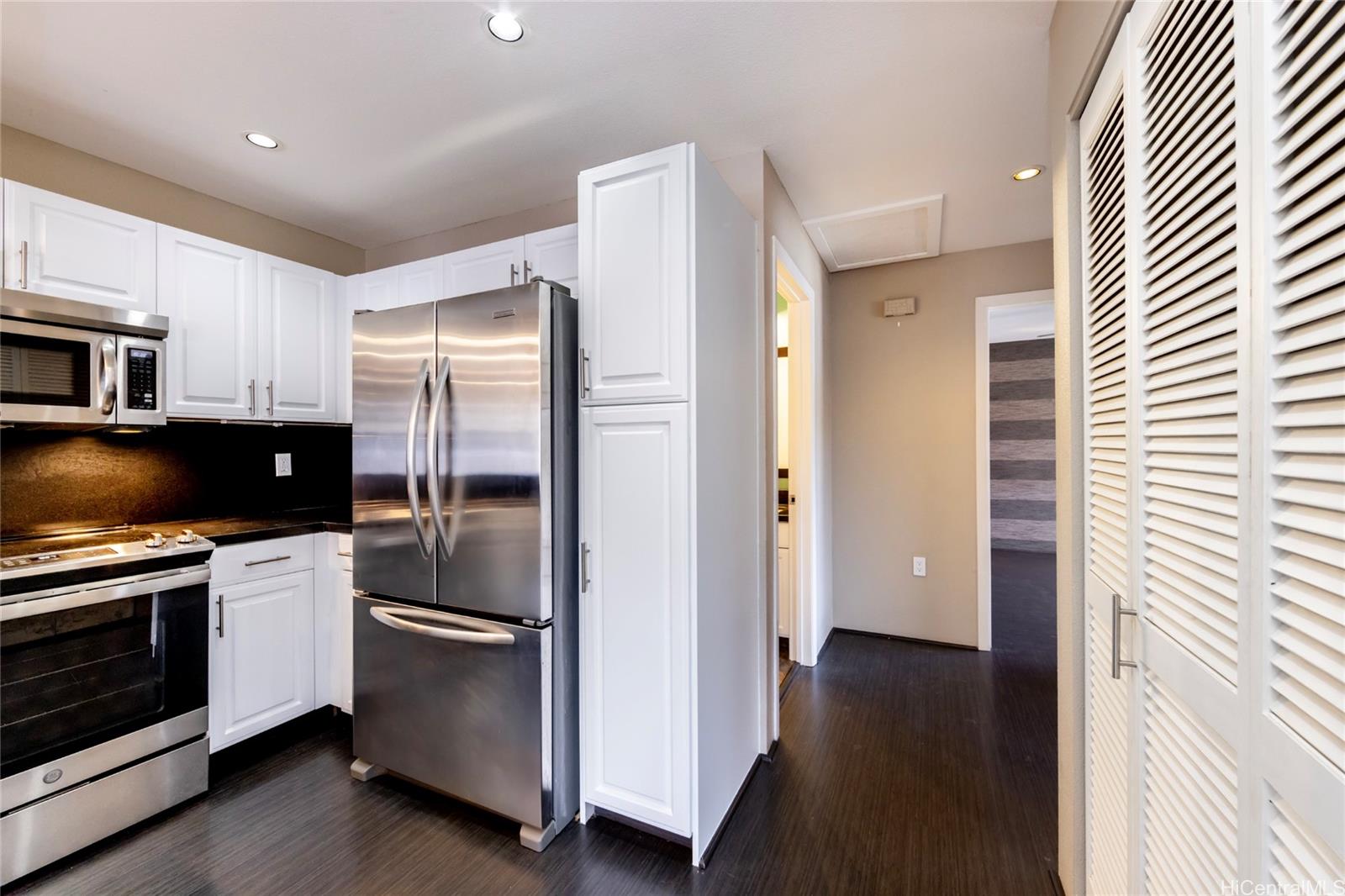 92-1475 Ali'inui Drive, Unit 20B Kapolei, HI 96707 - Photo 7 of 18 a kitchen with stainless steel appliances a refrigerator and a stove top oven