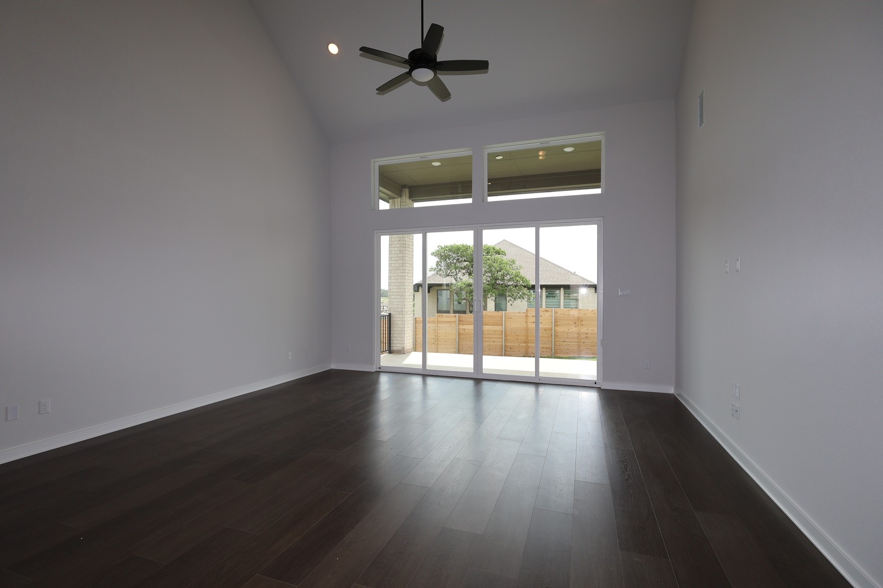 436 Leaning Rock Road Georgetown, TX 78628 - Photo 4 of 22 an empty room with wooden floor and windows