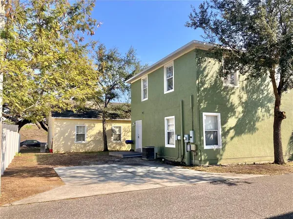 a view of a house with a yard and garage