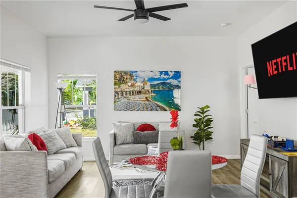 a living room with furniture and a potted plant