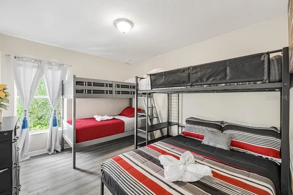 a bedroom with bed and a window