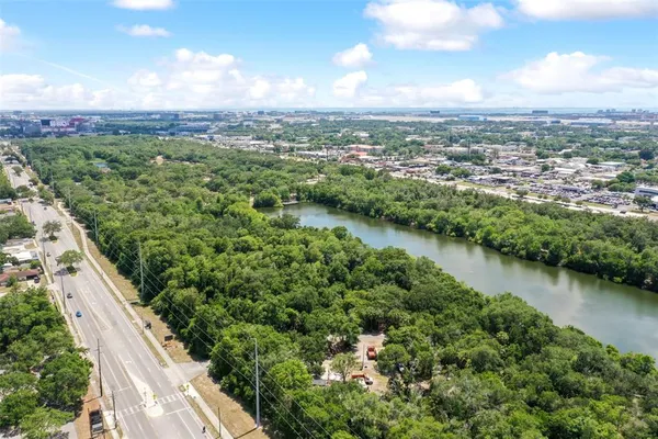an aerial view of residential houses with outdoor space and river