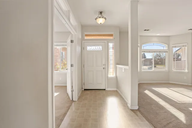 wooden floor with a chandelier in a room