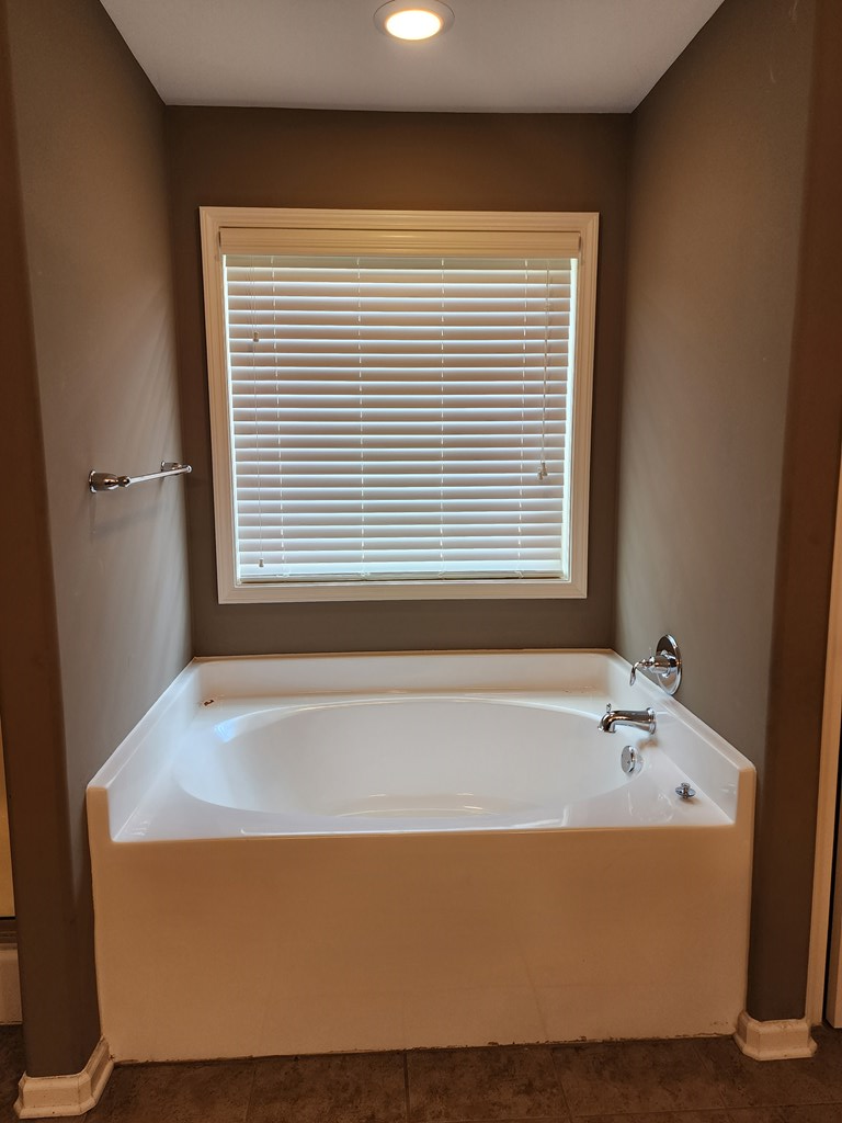 4924 Brightstar Lane Columbus, GA 31907 - Photo 17 of 21 a bath tub sitting in a bathroom next to a window