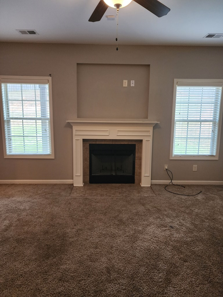 4924 Brightstar Lane Columbus, GA 31907 - Photo 6 of 21 an empty room with a fireplace and windows