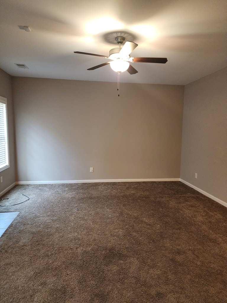 4924 Brightstar Lane Columbus, GA 31907 - Photo 7 of 21 a view of an empty room with a chandelier fan