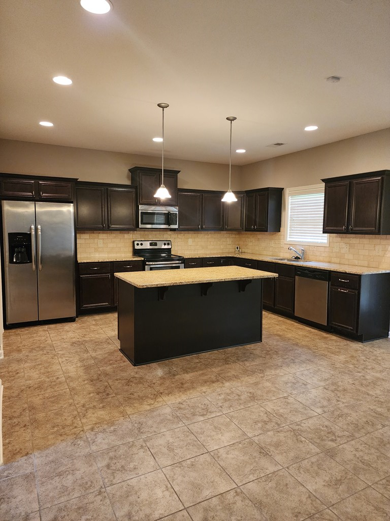 4924 Brightstar Lane Columbus, GA 31907 - Photo 8 of 21 a large kitchen with kitchen island a sink and a stove