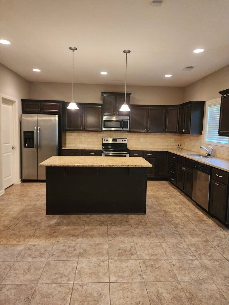 4924 Brightstar Lane Columbus, GA 31907 - Photo 9 of 21 a large kitchen with kitchen island a sink stainless steel appliances and cabinets