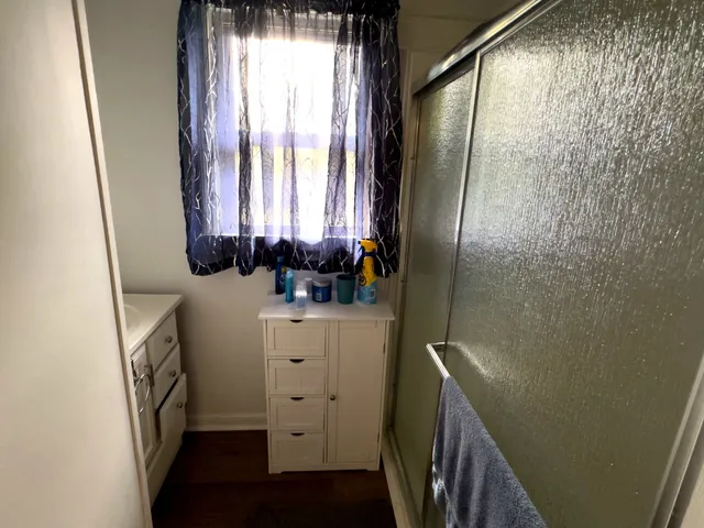 a bathroom with a sink a mirror and a window