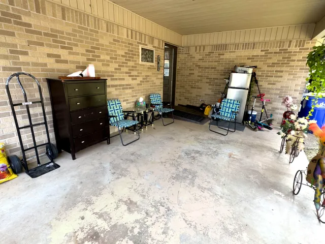 a view of a house with swimming pool and sitting area