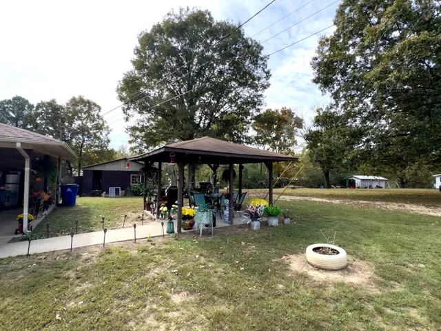 a view of a house with a yard and sitting area