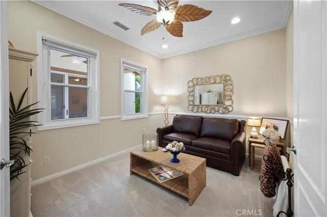 a bedroom with furniture and a flat screen tv