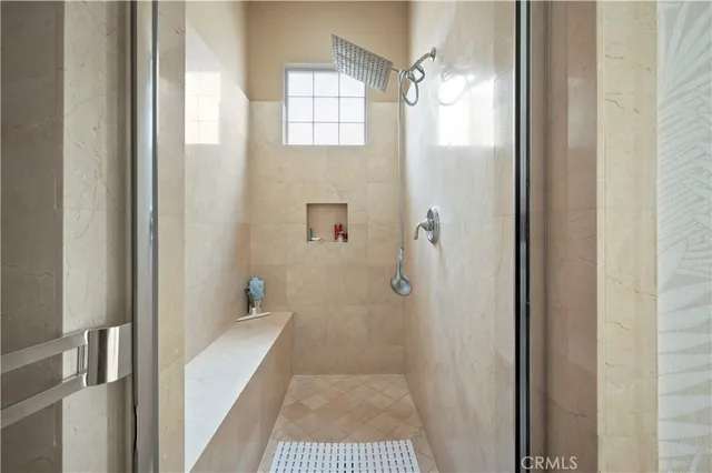 a bedroom with a bed and a large mirror